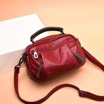 Finbjorg  Small and versatile bag in golden cognac shade